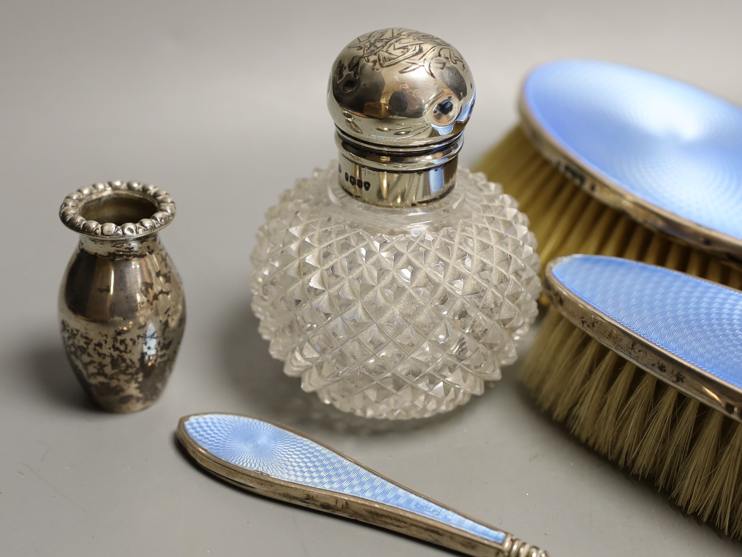 Two silver mounted glass scent bottles, a miniature Scottish silver vase, a five piece silver and guilloche enamelled dressing table set and a small group of assorted silver and sterling flatware